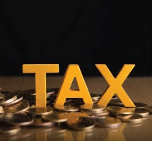 Tax Word on Top of Coins for Services in Monaghan